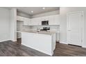 Modern kitchen featuring white cabinets, stainless steel appliances, and center island perfect for entertaining at 2177 Flower Blossom Ave, Brighton, CO 80601