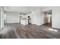 Spacious living area boasts an open-concept design, seamlessly connecting living, dining, and kitchen spaces at 2177 Flower Blossom Ave, Brighton, CO 80601