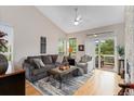 Cozy living room with vaulted ceiling and sliding door to balcony at 9441 Southern Hills Cir, Lone Tree, CO 80124