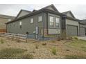 View of the home's side exterior, fenced yard, and low maintenance landscaping at 11860 Sandcastle Ct, Parker, CO 80138