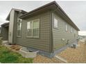 View of the home's side exterior and low maintenance landscaping at 11860 Sandcastle Ct, Parker, CO 80138