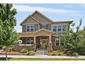 Charming two-story home with a covered front porch, stone accents, and manicured landscaping at 5663 W 96Th Ave, Westminster, CO 80020
