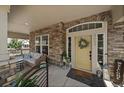 Inviting covered front porch with stone accents, seating area, and stylish decor at 5663 W 96Th Ave, Westminster, CO 80020