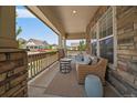 Relaxing covered front porch with a comfortable seating area and charming neighborhood views at 5663 W 96Th Ave, Westminster, CO 80020