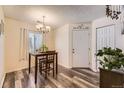 Bright dining area with modern lighting, seating, and stylish flooring at 3600 S Pierce St # 106, Lakewood, CO 80235