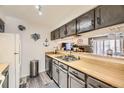 Well-lit kitchen with wood countertops, stainless steel appliances and ample cabinet space at 3600 S Pierce St # 106, Lakewood, CO 80235