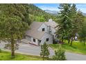 Charming home featuring a unique roofline surrounded by mature trees at 1129 Genesee Vista Rd, Golden, CO 80401