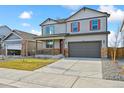 Inviting two-story home boasts a covered porch, stone accents, and a spacious two-car garage for modern living at 27684 E Byers Ave, Aurora, CO 80018