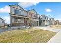 A well-maintained two-story home, with a landscaped front yard and a covered porch, perfect for suburban living at 27684 E Byers Ave, Aurora, CO 80018