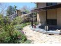 Paver stone patio and walkways in the backyard with mature landscaping and trees at 8095 E Lehigh Ave, Denver, CO 80237