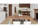 Cozy dining area featuring a fireplace, barstool seating, and an open-concept design at 2960 S Parker Ct, Aurora, CO 80014