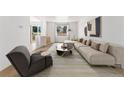 Inviting living room with neutral tones, a modern sofa, stylish decor, and ample natural light at 2960 S Parker Ct, Aurora, CO 80014