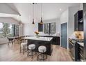 Modern kitchen with an island, seating, stainless steel appliances, and mountain views at 578 American Way, Breckenridge, CO 80424