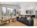 Open-concept living space featuring contemporary furnishings, large windows, and a view into the kitchen at 578 American Way, Breckenridge, CO 80424
