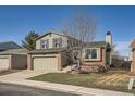 Two-story home with attached garage, featuring a manicured front lawn and brick accents at 8370 Sandreed Cir, Parker, CO 80134