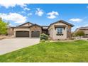 Two-story home with stone accents and a three-car garage at 2434 Marshall Ct, Erie, CO 80516