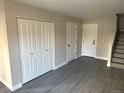 Living room with hardwood floors, closet, and staircase access at 1642 N Lafayette St # 5, Denver, CO 80218