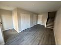 Spacious living room with hardwood floors, closet, and staircase access at 1642 N Lafayette St # 5, Denver, CO 80218