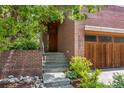 Inviting front entrance with brick facade, manicured landscaping and steps leading to the front door at 350 Holly St, Denver, CO 80220