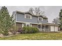 Traditional two-story home with a brick and siding exterior and a covered front porch at 3270 S Krameria St, Denver, CO 80222