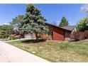 The home is complemented by mature trees and manicured landscaping at 7778 S Cherry Ct, Centennial, CO 80122