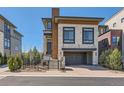 Contemporary home with stone accents, wood details, a covered entryway, and an attached two-car garage at 10119 Bellwether Ln, Lone Tree, CO 80124