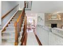 Inviting living room showcasing a staircase, fireplace, and elegant hardwood flooring at 7589 S Cove Cir, Centennial, CO 80122