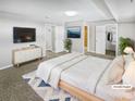 Staged main bedroom featuring neutral tones, a large bed, and ample closet space at 3957 S Boston St, Denver, CO 80237