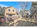 A spacious backyard with a well-maintained lawn, wooden deck, and mature trees offers outdoor living at 2488 W 111Th Pl, Denver, CO 80234