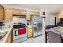 Functional kitchen with stainless steel appliances, ample cabinet space, and tile flooring at 465 Miller Ave, Brighton, CO 80601