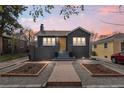 Charming home featuring a landscaped front yard, brick facade, and inviting entryway at 1445 Ash St, Denver, CO 80220