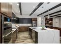 Modern kitchen with sleek cabinets, stainless steel appliances, and a large center island at 16244 Thunder Cat Way, Monument, CO 80132