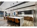 Modern kitchen featuring a large island, sleek cabinetry, stainless steel appliances, and stylish pendant lighting at 16244 Thunder Cat Way, Monument, CO 80132