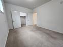 Bright bedroom has a walk-in closet and neutral carpeting at 9220 Wilde Ln # 102, Parker, CO 80134