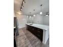Bright kitchen features a large island with stainless steel appliances and modern pendant lighting at 9220 Wilde Ln # 102, Parker, CO 80134