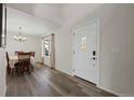 Bright entryway with hardwood floors, chandelier, and formal dining area at 3929 S Quemoy Ct, Aurora, CO 80018