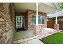 Inviting brick porch features white columns and trim, with a glass front door entrance at 2078 Goldfinch Ct, Longmont, CO 80503
