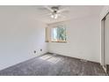 Bright bedroom with neutral carpet, a window letting in natural light, and a ceiling fan at 7897 Allison Way # 304, Arvada, CO 80005