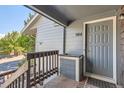 A unit entrance featuring a gray door and siding, with a small porch area at 7897 Allison Way # 304, Arvada, CO 80005