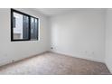 Bright bedroom with a large window offering plenty of natural light and neutral color palette at 1252 Yates St, Denver, CO 80204