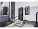 Home exterior featuring concrete steps to door, black and white paint, and modern design at 1252 Yates St, Denver, CO 80204