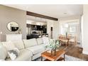 Open-concept living space showcasing hardwood floors, a dining area, and a modern kitchen at 2869 Kingston St, Denver, CO 80238