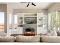Bright and airy living room with built-in shelving, a modern fireplace, and large windows at 2869 Kingston St, Denver, CO 80238
