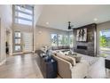 Bright living room with a modern fireplace, large windows, and contemporary furnishings with natural light at 6005 Beeler St, Denver, CO 80238