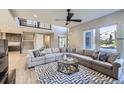 Spacious living room with a large sectional sofa, contemporary rug, and staircase to the upper level at 6005 Beeler St, Denver, CO 80238