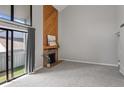 Spacious living room with a modern fireplace and sliding door to the balcony at 14046 E Stanford Cir # I11, Aurora, CO 80015
