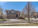Two-story home with an attached two-car garage and a well-maintained lawn at 1421 Rustic Dr, Longmont, CO 80504