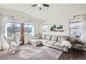 Spacious living room with large windows, comfortable seating, and neutral decor at 1421 Rustic Dr, Longmont, CO 80504