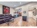 Open living room showcasing hardwood floors, stylish decor, and a glimpse of the kitchen at 3022 S Wheeling S Way # 410, Aurora, CO 80014