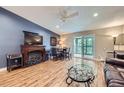 Comfortable living room with fireplace, TV, sliding door, ceiling fan and stylish decor at 3022 S Wheeling S Way # 410, Aurora, CO 80014